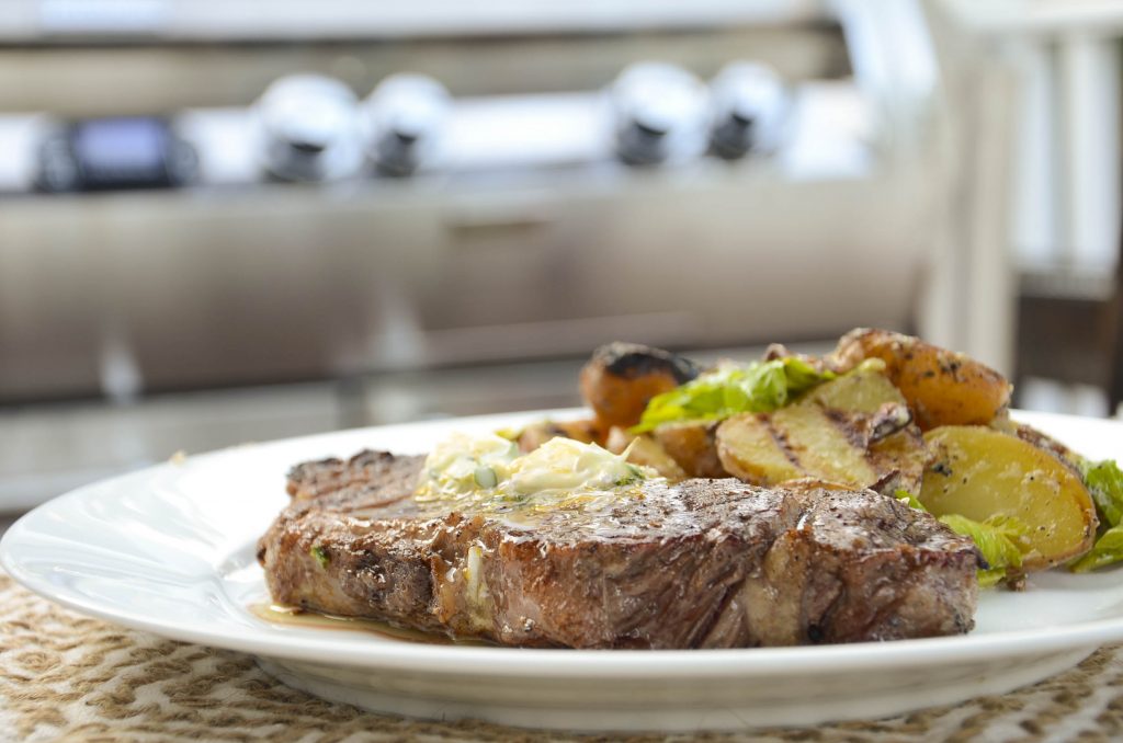 steak with butter and potatoes